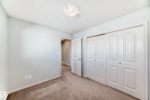 Neutral-toned carpeting paired with light blue painted walls - 6723 19 Avenue, Edmonton, AB 