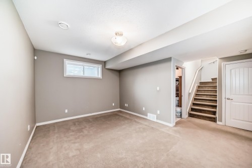 Lower level recreation area featuring neutral tone carpeting and painted walls - 6723 19 Avenue, Edmonton, AB 