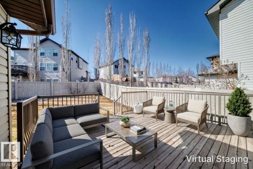 Spacious backyard deck featuring wood-finish decking and railing with direct stairs to the yard - 6723 19 Avenue, Edmonton, AB 