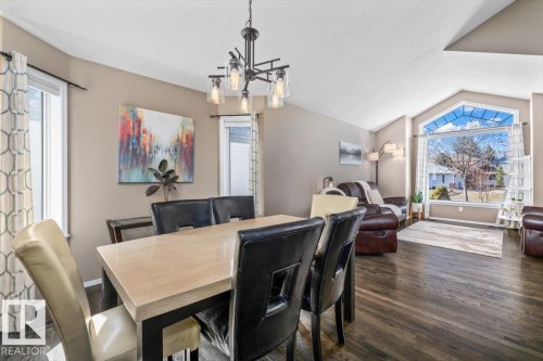 Open-concept living space with dark wood-finish flooring - 86 Westpark Way, Fort Saskatchewan, AB - Indoor Photo Showing Dining Room