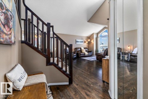 Hardwood-finish flooring extending from the entryway into the living area - 86 Westpark Way, Fort Saskatchewan, AB - Indoor Photo Showing Other Room