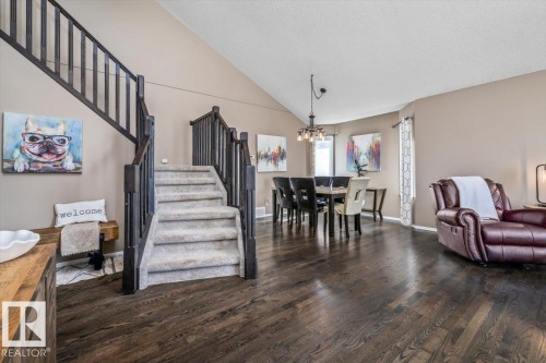Open-concept living space featuring wood-finish flooring and a vaulted ceiling - 86 Westpark Way, Fort Saskatchewan, AB - Indoor