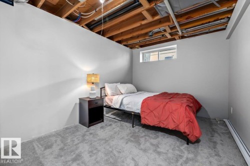 Finished lower level space featuring light gray walls, plush gray carpeting, and an egress window - 86 Westpark Way, Fort Saskatchewan, AB - Indoor Photo Showing Bedroom