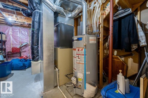 Basement utility area featuring a water heater, furnace, exposed ductwork, and PEX plumbing - 86 Westpark Way, Fort Saskatchewan, AB - Indoor Photo Showing Basement