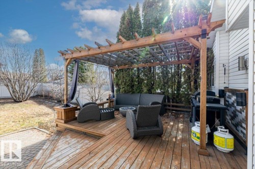 Expansive wood deck featuring a built-in pergola with privacy curtains - 86 Westpark Way, Fort Saskatchewan, AB - Outdoor With Deck Patio Veranda
