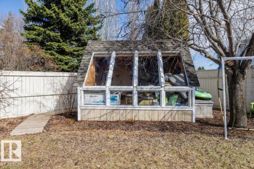 Freestanding A-frame structure featuring a shingled roof, glass panels, and a wood-paneled base - 86 Westpark Way, Fort Saskatchewan, AB - Outdoor