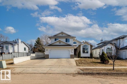 Two-story residence featuring a front-facing attached garage, a bay window with a transom, and a concrete driveway - 86 Westpark Way, Fort Saskatchewan, AB - Outdoor With Facade