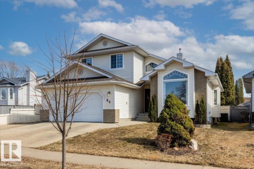 Two-story home with light-colored siding and brick accents - 86 Westpark Way, Fort Saskatchewan, AB - Outdoor With Facade
