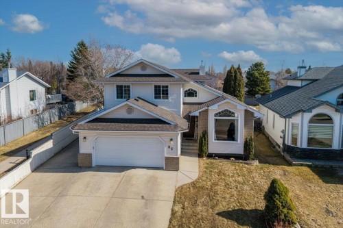 Two-story residence featuring light-colored siding and a multi-pitched roofline - 86 Westpark Way, Fort Saskatchewan, AB - Outdoor With Facade