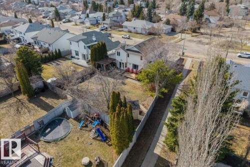 Aerial view showcasing a residential neighborhood with detached homes, mature trees, and paved streets - 86 Westpark Way, Fort Saskatchewan, AB - Outdoor With View