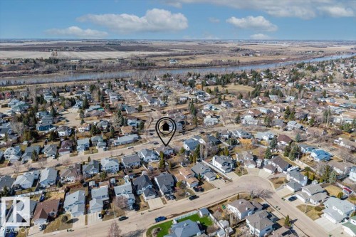 Aerial perspective showcasing a residential neighborhood with a river in the background and surrounding open terrain - 86 Westpark Way, Fort Saskatchewan, AB - Outdoor With View
