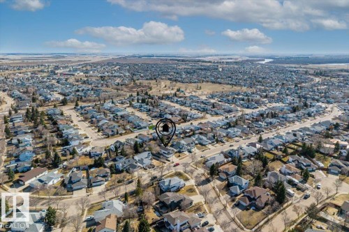 Aerial perspective of a residential neighborhood featuring numerous detached properties with varied rooflines and lot sizes, surrounded by mature trees - 86 Westpark Way, Fort Saskatchewan, AB - Outdoor With View