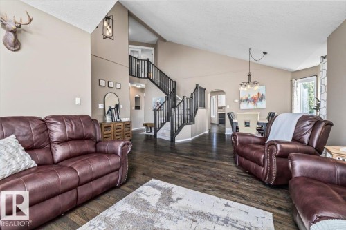 Vaulted ceilings with exposed beams and dark wood-finish flooring - 86 Westpark Way, Fort Saskatchewan, AB - Indoor Photo Showing Living Room