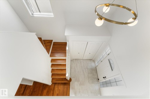 Entry foyer with wood-finish stairs and a skylight - 326 Silver Berry Road, Edmonton, AB - Indoor Photo Showing Other Room