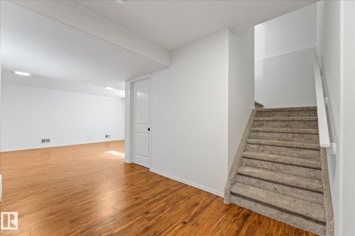 Spacious room featuring wood-finish flooring, white walls, and recessed lighting - 326 Silver Berry Road, Edmonton, AB - Indoor Photo Showing Other Room