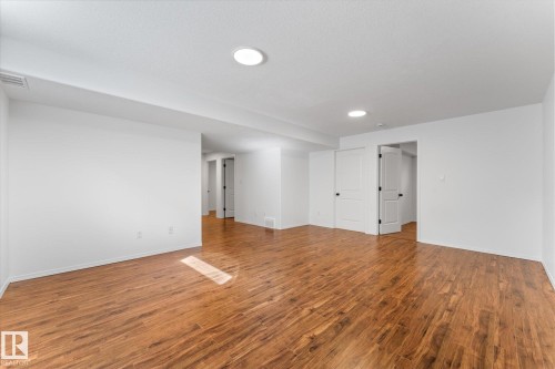 Spacious room with wood-finish flooring, recessed lighting, and crisp white walls - 326 Silver Berry Road, Edmonton, AB - Indoor Photo Showing Other Room