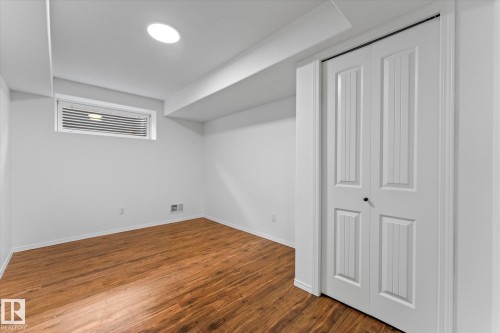 Room featuring wood-finish flooring, white walls, and a recessed ceiling light - 326 Silver Berry Road, Edmonton, AB - Indoor Photo Showing Other Room