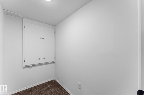 White wall-mounted cabinetry with two doors, finished with neutral hardware - 326 Silver Berry Road, Edmonton, AB - Indoor Photo Showing Other Room