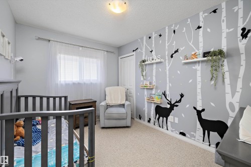 Interior room featuring light gray walls, a window with sheer white curtains, and neutral carpet flooring - 992 Regency Drive, Sherwood Park, AB - Indoor