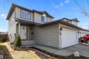 Two-story residence featuring light gray siding, an attached garage, a white entry door with a decorative glass insert, and a covered porch - 992 Regency Drive, Sherwood Park, AB  - Outdoor 