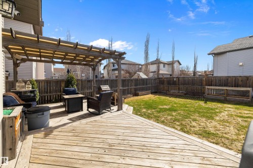 Expansive wood-finish deck featuring a pergola structure and direct access to a fenced yard - 992 Regency Drive, Sherwood Park, AB - Outdoor With Exterior