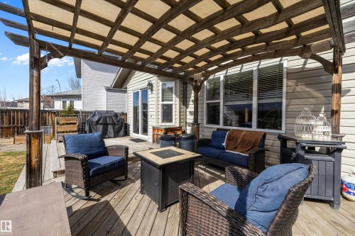 Expansive wood deck featuring a covered pergola with a canvas shade, providing an outdoor living area - 992 Regency Drive, Sherwood Park, AB - Outdoor With Deck Patio Veranda With Exterior
