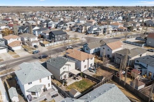 Residential neighborhood featuring a variety of single-family homes, paved streets, and mature tree lines in the distance - 992 Regency Drive, Sherwood Park, AB - Outdoor With View