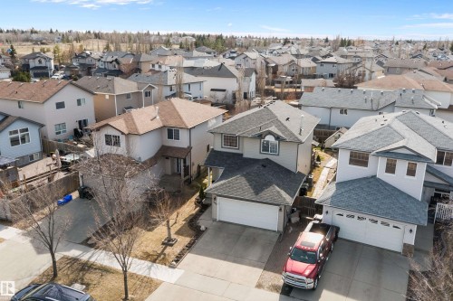 Two-story detached home featuring a light-colored stucco exterior with dark shingle roofing - 992 Regency Drive, Sherwood Park, AB - Outdoor