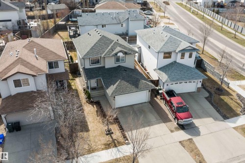Two-story residence featuring light-colored siding, a dark shingle roof, and an attached two-car garage - 992 Regency Drive, Sherwood Park, AB - Outdoor