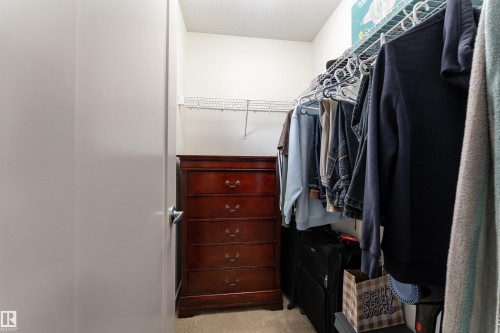 Walk-in closet featuring carpet flooring, white walls, and a wire shelving system - 15 5203 149 Avenue, Edmonton, AB - Indoor With Storage