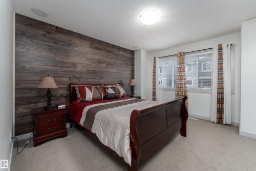 Accent wall featuring horizontal wood-finish paneling - 15 5203 149 Avenue, Edmonton, AB - Indoor Photo Showing Bedroom