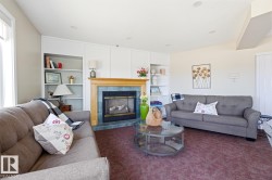 Common area featuring a gas fireplace with a wood mantle and blue tile surround - 