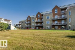 Multi-story residential building featuring brick and horizontal siding facades - 