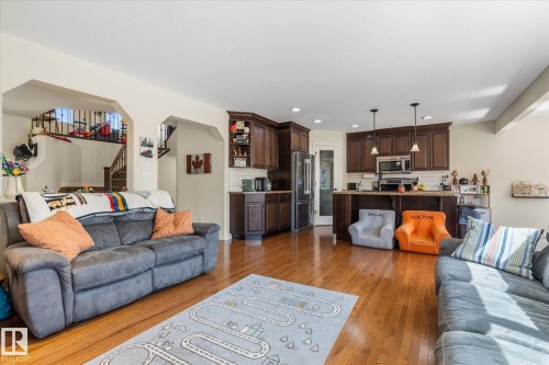 Open-concept living area featuring hardwood flooring throughout - 41 Heron Crescent, Spruce Grove, AB - Indoor Photo Showing Living Room