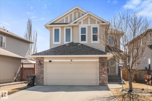 Two-story residence featuring a neutral-toned facade with stone accents and a covered entrance - 41 Heron Crescent, Spruce Grove, AB - Outdoor
