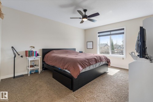 Carpeted room featuring a window with horizontal blinds, a ceiling fan with integrated lighting, and neutral wall tones - 41 Heron Crescent, Spruce Grove, AB - Indoor Photo Showing Bedroom