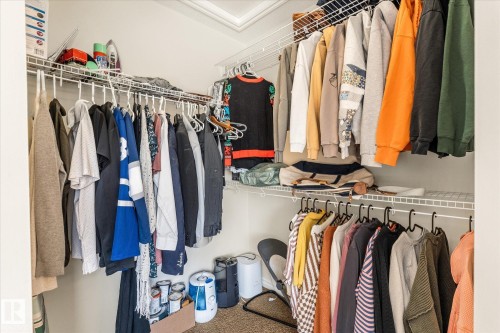 Walk-in closet featuring white wire shelving and hanging rods - 41 Heron Crescent, Spruce Grove, AB - Indoor With Storage