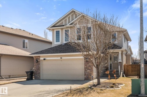 Two-story residential property featuring a tan exterior with stone veneer accents - 41 Heron Crescent, Spruce Grove, AB - Outdoor