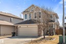 Two-story residential property featuring a tan exterior with stone veneer accents - 41 Heron Crescent, Spruce Grove, AB  - Outdoor 