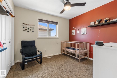 Bright room featuring a window with white trim, brown carpet flooring, and a ceiling fan with integrated lighting - 41 Heron Crescent, Spruce Grove, AB - Indoor Photo Showing Other Room
