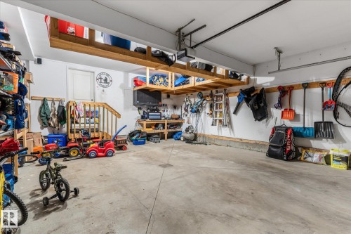 Spacious garage featuring concrete flooring and white painted walls - 41 Heron Crescent, Spruce Grove, AB - Indoor Photo Showing Garage