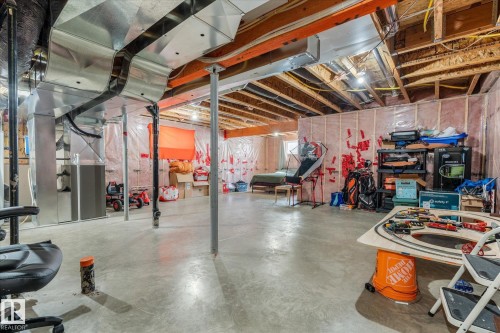 Expansive unfinished basement featuring a concrete floor, exposed wood ceiling joists, and visible insulation along the perimeter walls - 41 Heron Crescent, Spruce Grove, AB - Indoor Photo Showing Basement