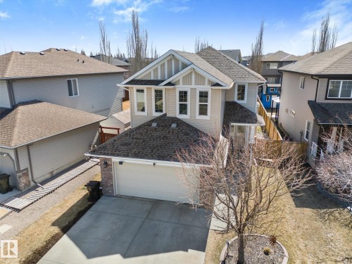 Two-story residence featuring light-toned siding and dark shingle roofing - 41 Heron Crescent, Spruce Grove, AB - Outdoor