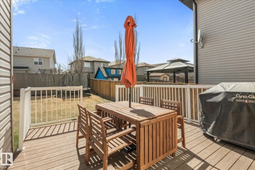 Spacious backyard deck featuring composite wood-finish decking and white railings - 41 Heron Crescent, Spruce Grove, AB - Outdoor With Deck Patio Veranda With Exterior