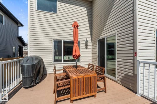 Elevated outdoor deck space featuring composite decking, white railing system, and vinyl siding - 41 Heron Crescent, Spruce Grove, AB - Outdoor With Deck Patio Veranda With Exterior