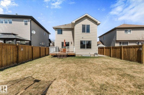 Rear exterior with a wood deck, white railing, and a privacy fence enclosing the yard - 41 Heron Crescent, Spruce Grove, AB - Outdoor With Exterior