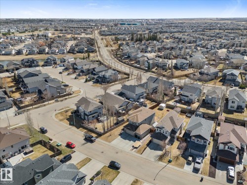 Residential neighborhood featuring a variety of detached homes with attached garages, asphalt shingle roofs, and paved driveways - 41 Heron Crescent, Spruce Grove, AB - Outdoor With View