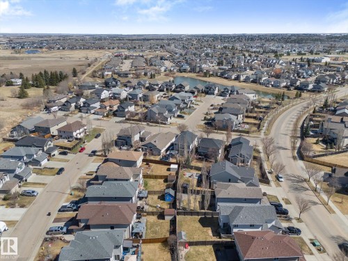 Expansive residential community featuring a variety of single-family homes with diverse rooflines and exterior finishes, tree-lined streets, and open green spaces - 41 Heron Crescent, Spruce Grove, AB - Outdoor With View