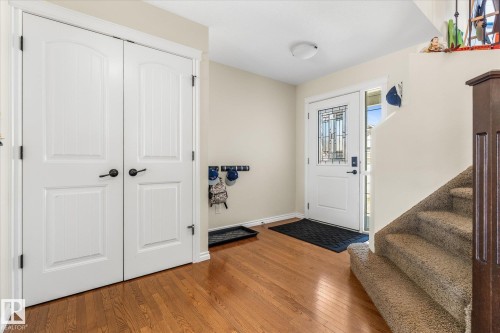 Inviting entryway featuring wood-finish flooring and a white front door with decorative glass inserts - 41 Heron Crescent, Spruce Grove, AB - Indoor Photo Showing Other Room