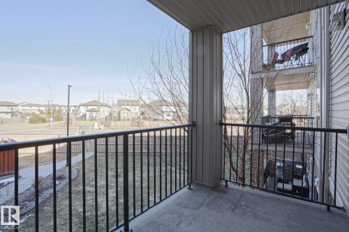 Concrete balcony with black metal railings, offering an outdoor extension of the living space - 201 1520 Hammond Gate Gate, Edmonton, AB - Outdoor With Exterior